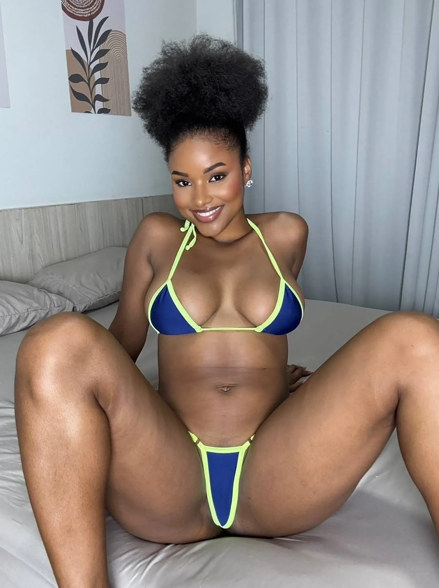 Hot Ebony OnlyFans Models A black woman poses confidently in a blue bikini and black panties, showcasing her style as an ebony OnlyFans model.